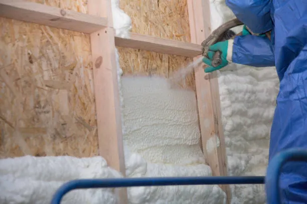 Foam is applied to the walls to warm the house at construction Foam is applied to the walls to warm the house at construction
